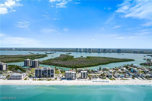 drone / aerial view featuring a water view and a beach view