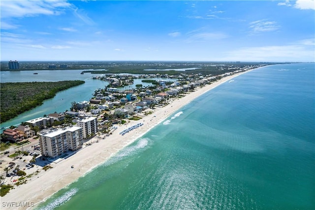 drone / aerial view featuring a water view and a beach view