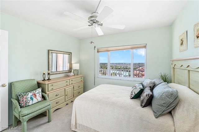 bedroom with ceiling fan and light carpet