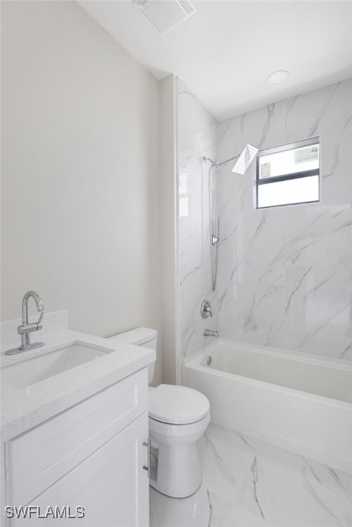 full bathroom with vanity, toilet, and tiled shower / bath