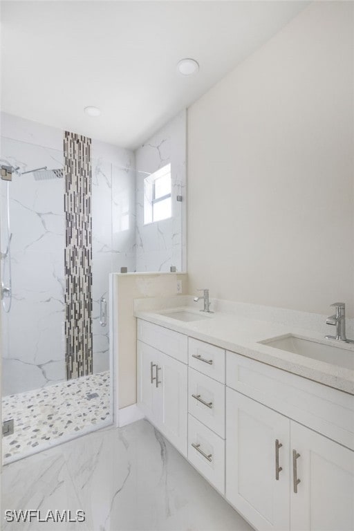 bathroom featuring a tile shower and vanity