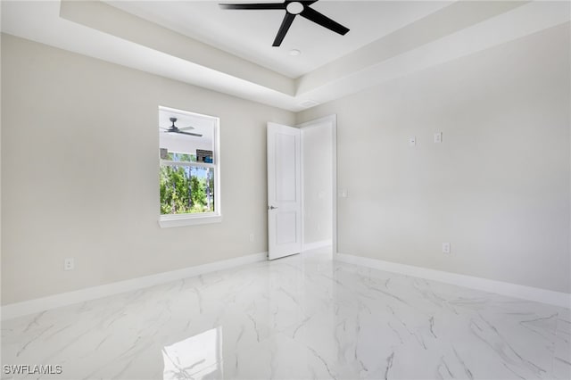 unfurnished room with a raised ceiling