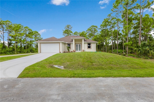 view of front of property with a front yard and a garage