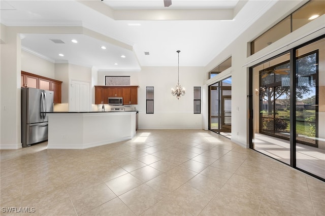 kitchen with a center island with sink, ornamental molding, decorative light fixtures, stainless steel appliances, and a chandelier