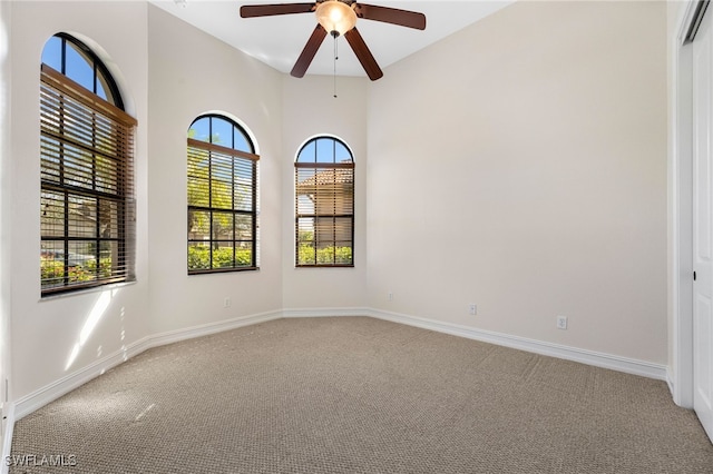 empty room featuring carpet flooring and ceiling fan