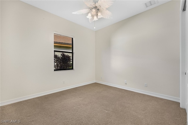 carpeted spare room with ceiling fan