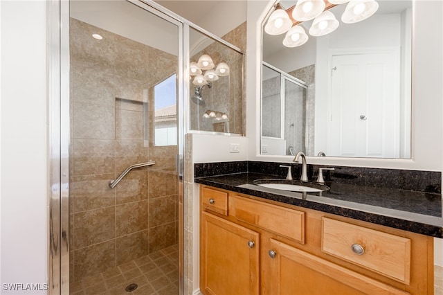 bathroom with vanity and a shower with door