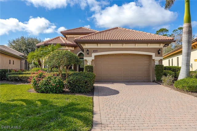 mediterranean / spanish-style house with a garage