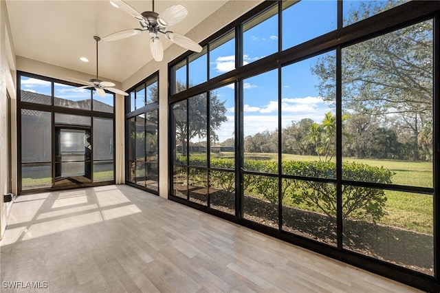 unfurnished sunroom featuring ceiling fan