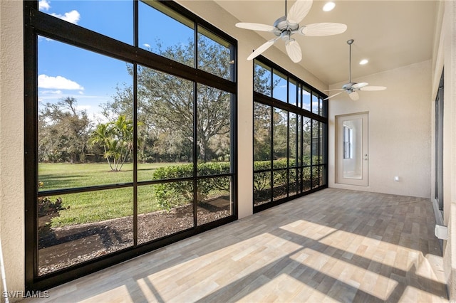 unfurnished sunroom featuring ceiling fan