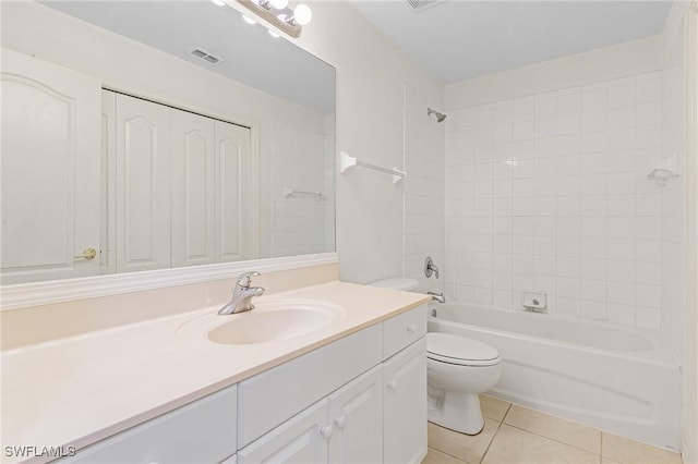 full bathroom featuring toilet, vanity, tile patterned floors, and tiled shower / bath