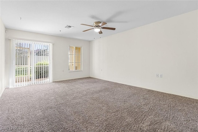 spare room featuring carpet and ceiling fan