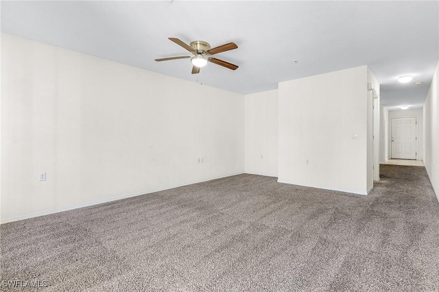 empty room with ceiling fan and carpet floors