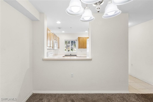 unfurnished room with light colored carpet