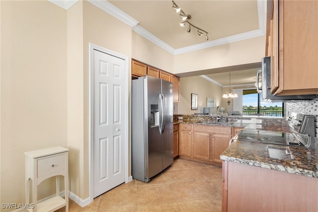 kitchen with pendant lighting, sink, stainless steel fridge, dark stone counters, and ornamental molding