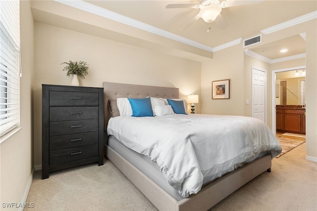 bedroom featuring crown molding, ceiling fan, connected bathroom, and light carpet