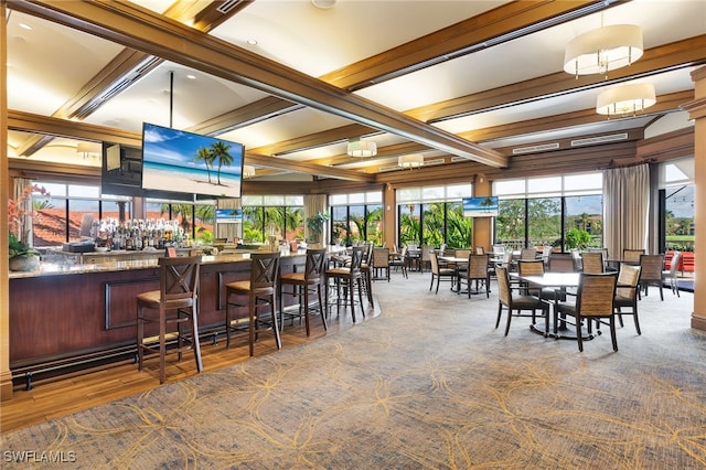 dining space with beamed ceiling, bar, and coffered ceiling