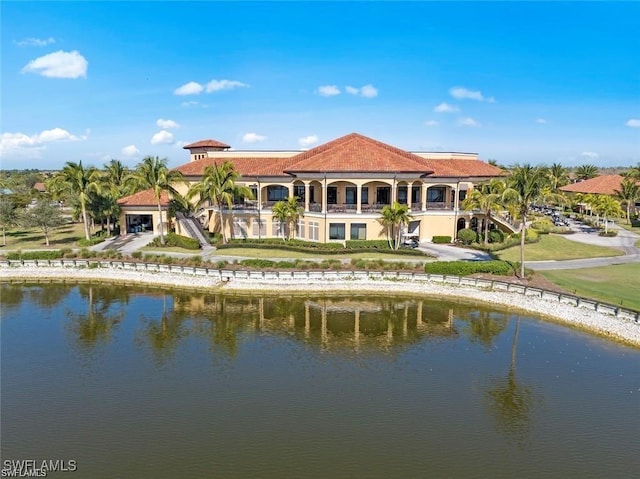 back of property featuring a water view