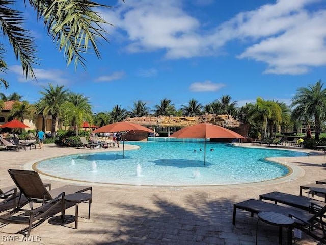 view of pool featuring pool water feature and a patio area