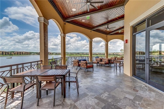 view of patio featuring a water view, an outdoor hangout area, ceiling fan, and french doors