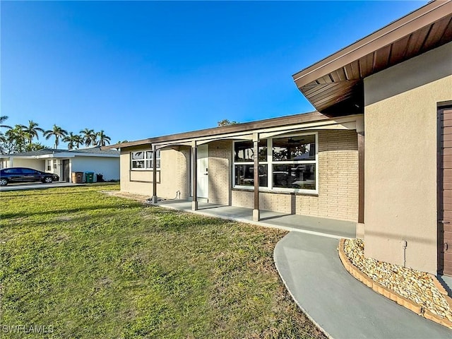 entrance to property featuring a lawn