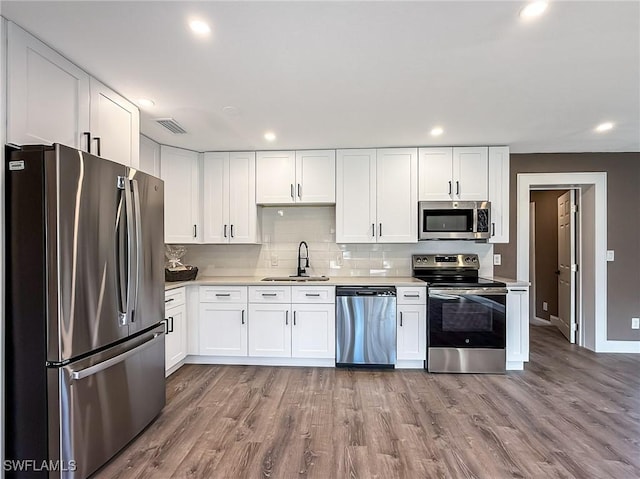 kitchen featuring sink, white cabinets, and appliances with stainless steel finishes