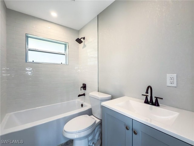 full bathroom featuring vanity, tiled shower / bath combo, and toilet