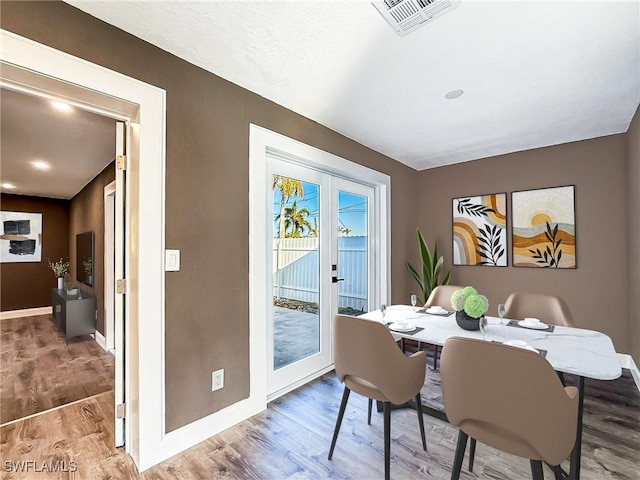 dining area featuring hardwood / wood-style floors and french doors