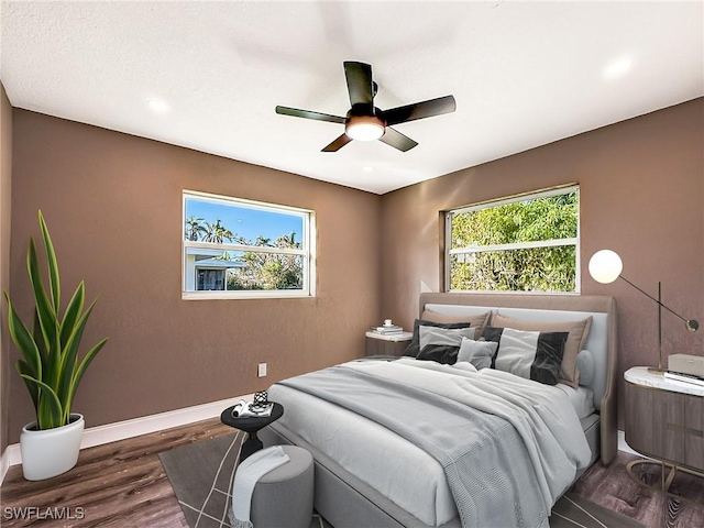 bedroom with ceiling fan and dark wood-type flooring