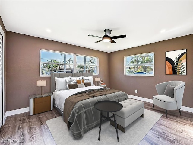 bedroom with hardwood / wood-style floors and ceiling fan