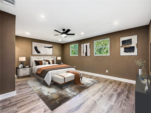 bedroom featuring light hardwood / wood-style flooring and ceiling fan