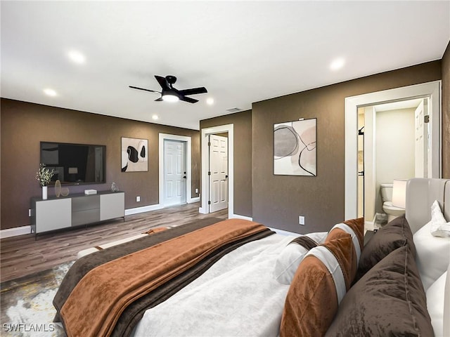 bedroom featuring ensuite bathroom, ceiling fan, and dark wood-type flooring