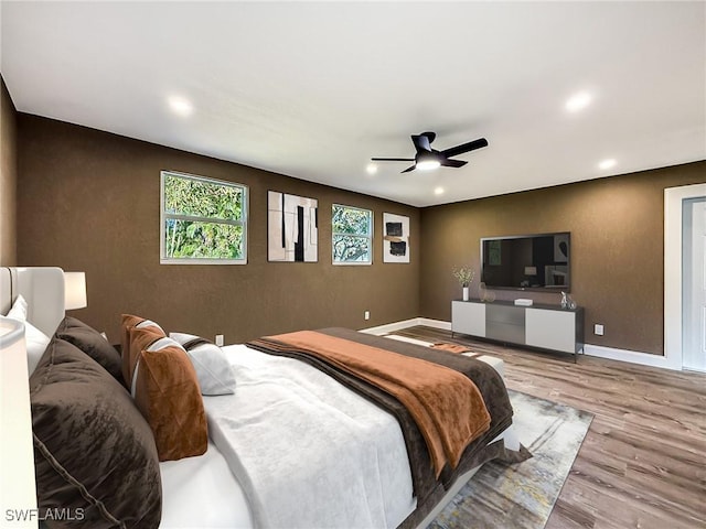 bedroom featuring ceiling fan and light hardwood / wood-style flooring