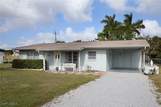 single story home with a carport and a front yard