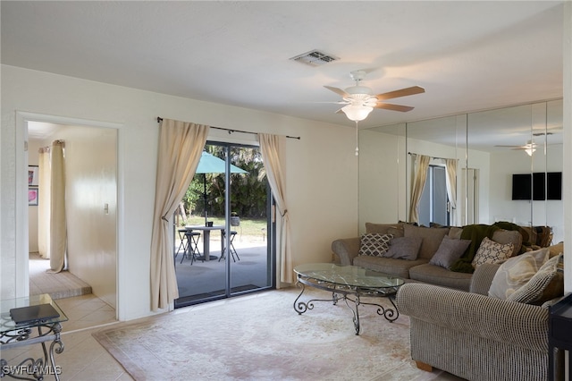 living room with ceiling fan and light tile patterned flooring