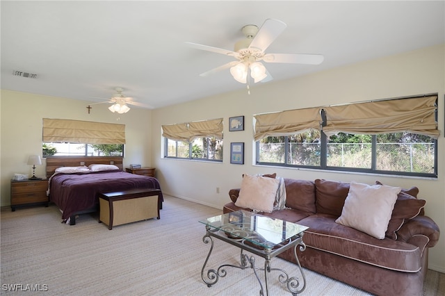 bedroom with ceiling fan and light carpet