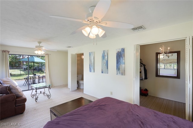 bedroom featuring ceiling fan with notable chandelier, access to exterior, and connected bathroom