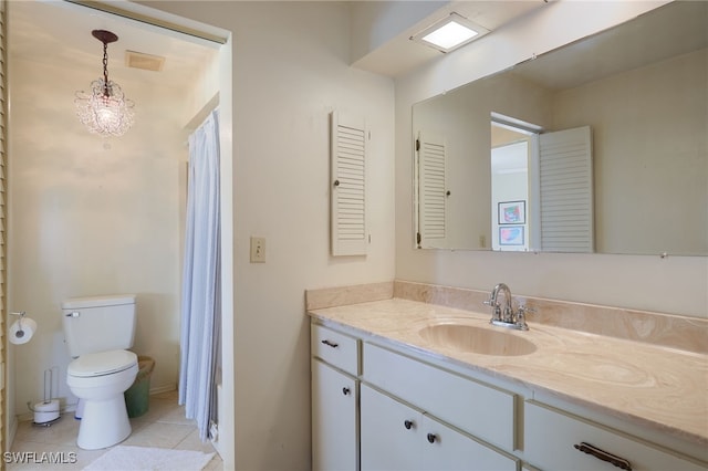 bathroom featuring tile patterned flooring, vanity, and toilet