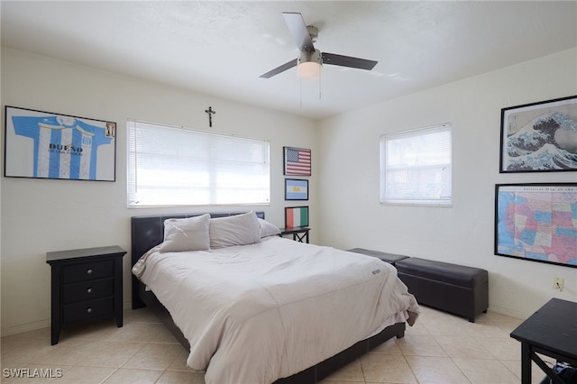 tiled bedroom with multiple windows and ceiling fan