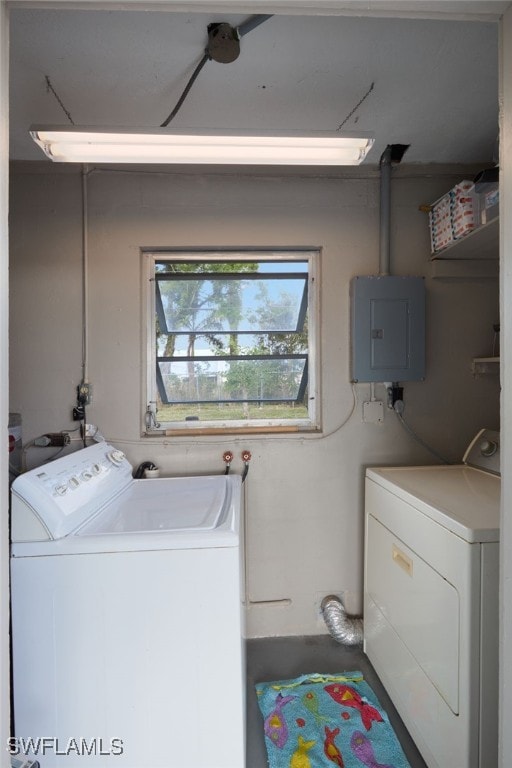 clothes washing area featuring washer and clothes dryer and electric panel