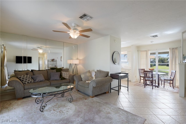 living room with ceiling fan and light tile patterned floors