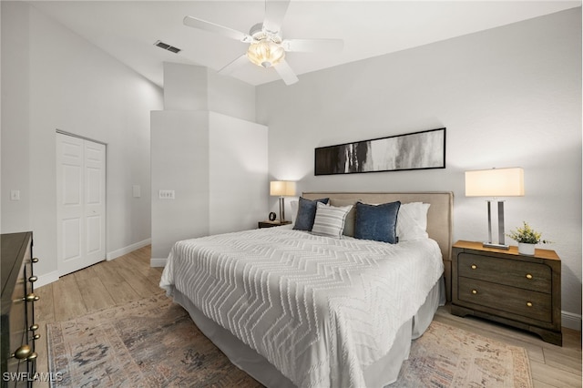 bedroom with ceiling fan, a closet, and hardwood / wood-style flooring