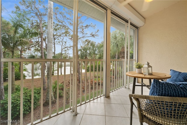 sunroom featuring a water view