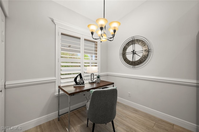 office area with vaulted ceiling, light hardwood / wood-style flooring, and an inviting chandelier