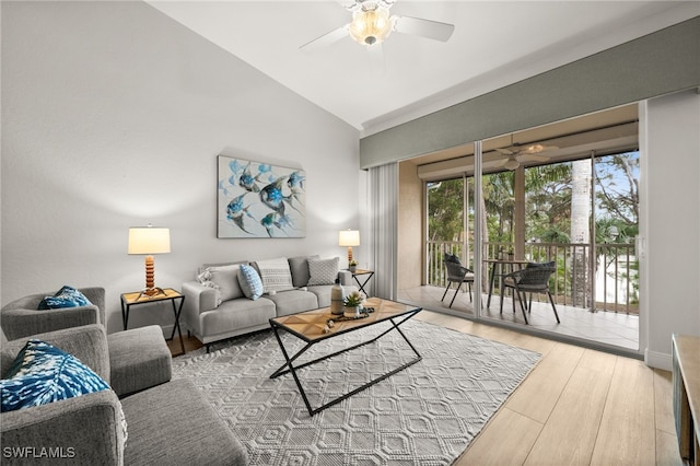 living room featuring ceiling fan, lofted ceiling, and hardwood / wood-style flooring