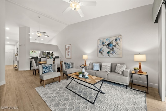 living room with vaulted ceiling, ceiling fan, and hardwood / wood-style floors