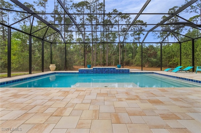 view of swimming pool with glass enclosure and a patio