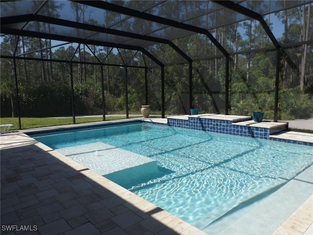 view of pool with a lanai and a patio area