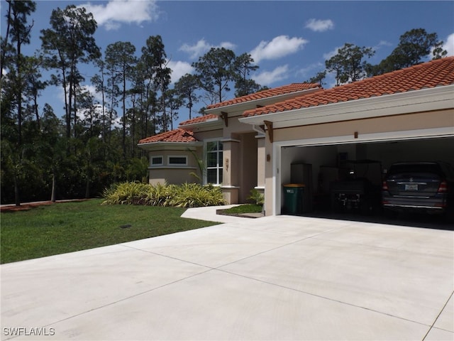 mediterranean / spanish house featuring a front lawn and a garage