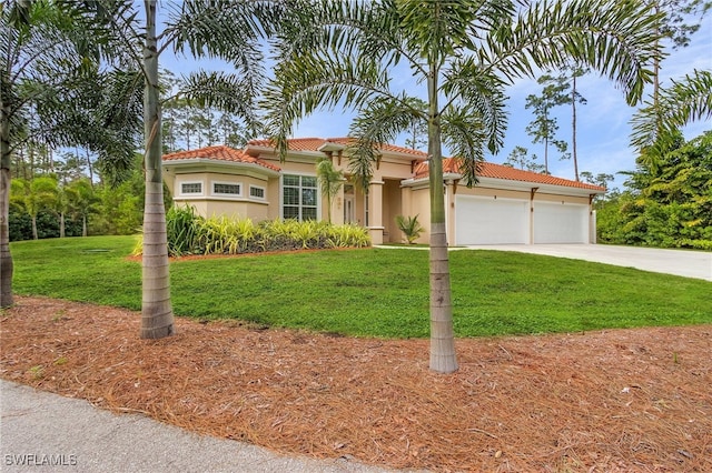 mediterranean / spanish-style home featuring a garage and a front yard